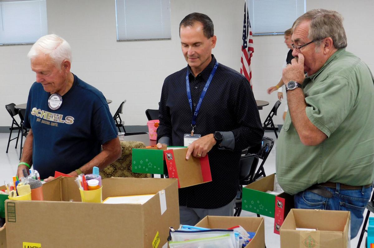 Noon Rotarian pack shoeboxes for Operation Christmas Child Community