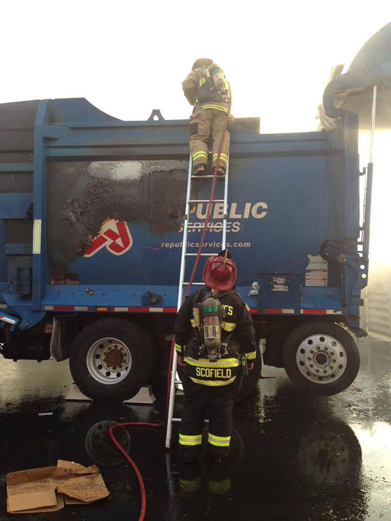 Firefighters battle garbage truck fire