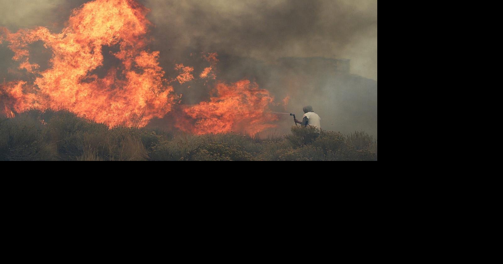 Homeowner Steven Phelps battles the Pinehaven Fire in the Caughlin Ranch area of Reno on Nov. 17, 2020.