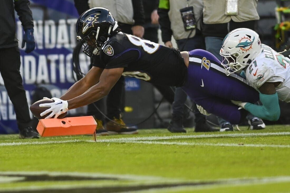 Ravens clinch AFC's No. 1 seed with 56-19 drubbing of Dolphins