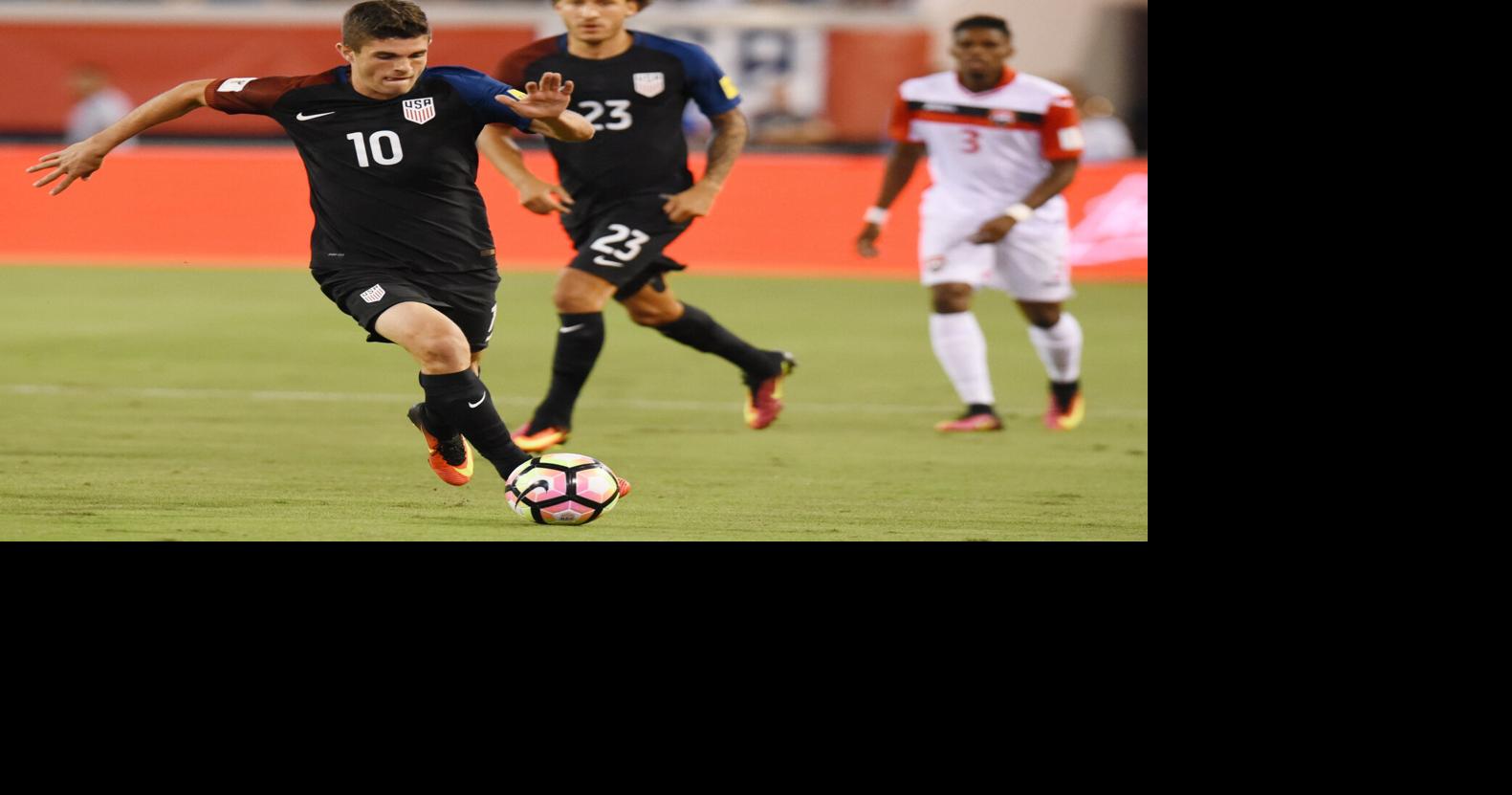 United States midfielder Christian Pulisic (10) moves the ball down the field during early game action against Trinidad &
