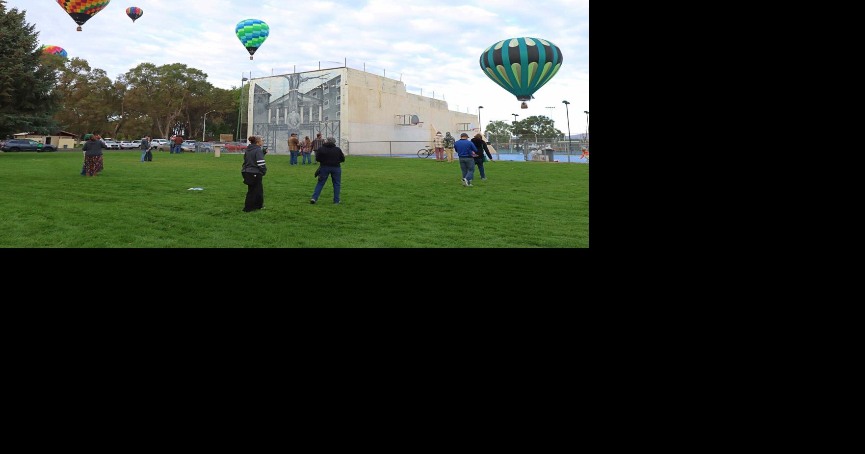 Hot air balloons fly over Elko City Park