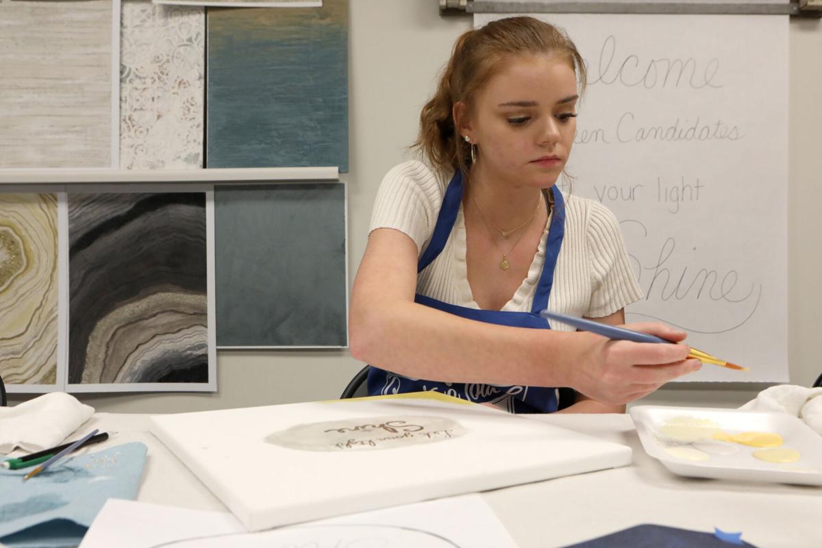 Kayla Kleekamp adds paint to her brush