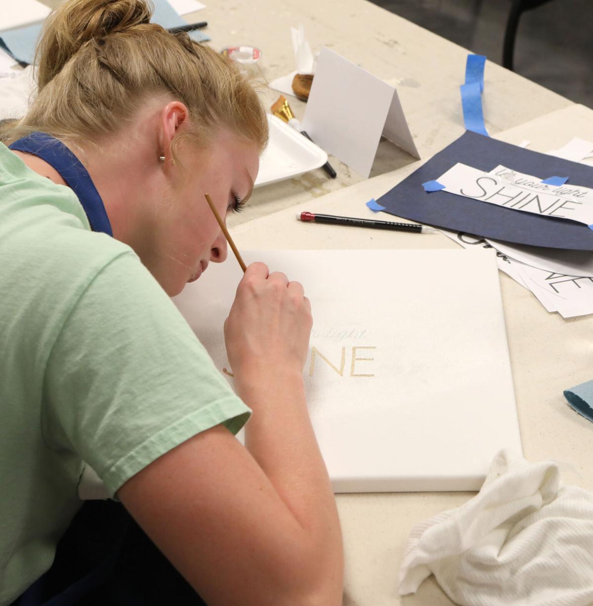 Aubrie Moreland paints over lettering
