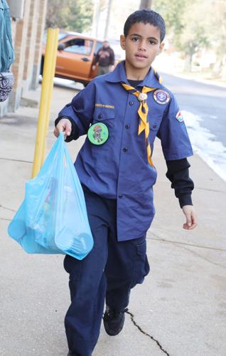 New scouts receive uniforms, donate food