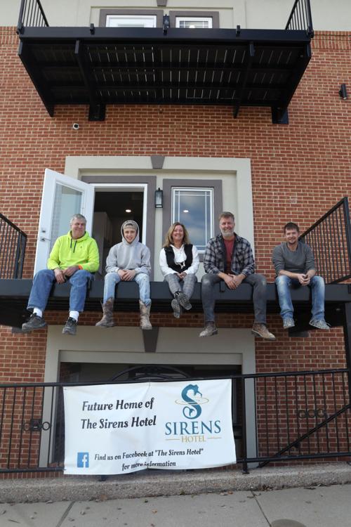 Staff and owners pose at Sirens Hotel