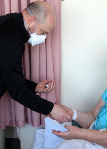Jim Theby anoints a Mercy Hospital patient