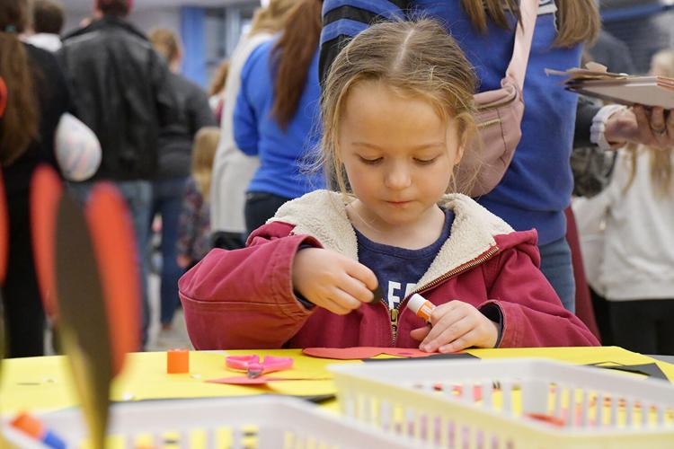 Nora Coulter makes a craft at Family Reading Night