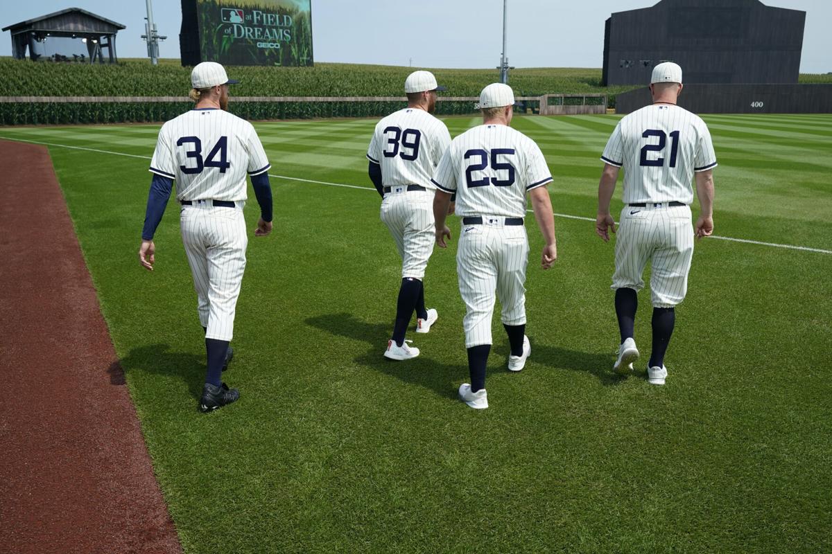 Dyersville, United States. 12th Aug, 2021. New York Yankees sit on the  stands from the 1989 movie set ballpark of the Field of Dreams as they  get ready for game at an