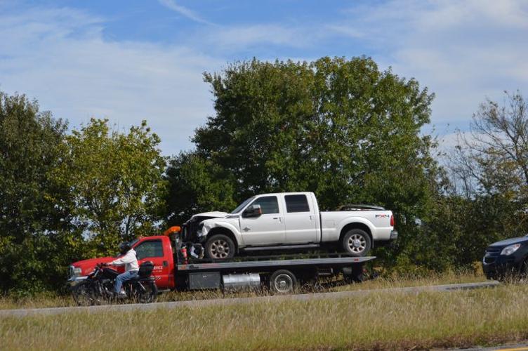 Pickup truck lays on sedan after crash on Eldora and Decatur