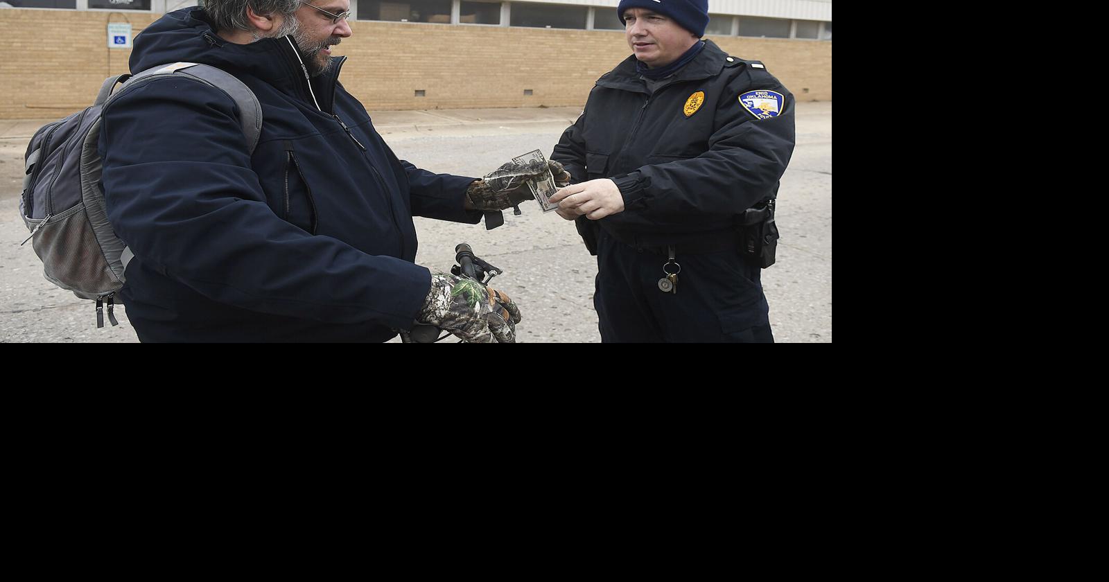 Police hand out cash to community members to spread holiday cheer ...