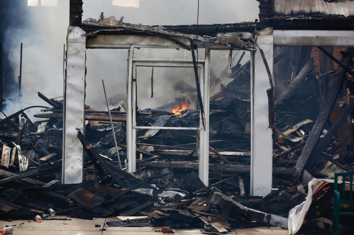 Firefighters douse hot spots after massive fire destroys historic