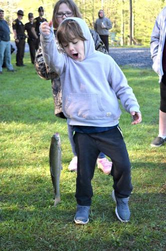 The Boy Sits and Catches Fish in a Pond