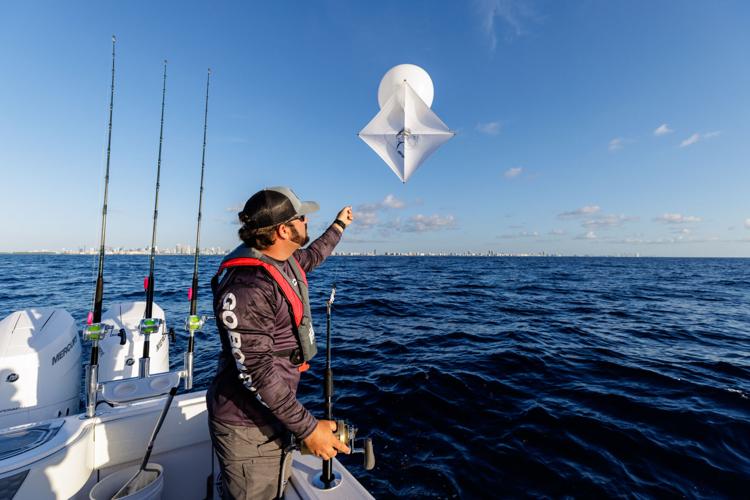 How do you control a fishing kite in strong wind?