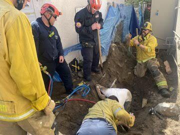 Two construction workers are rescued after being trapped in trench in ...