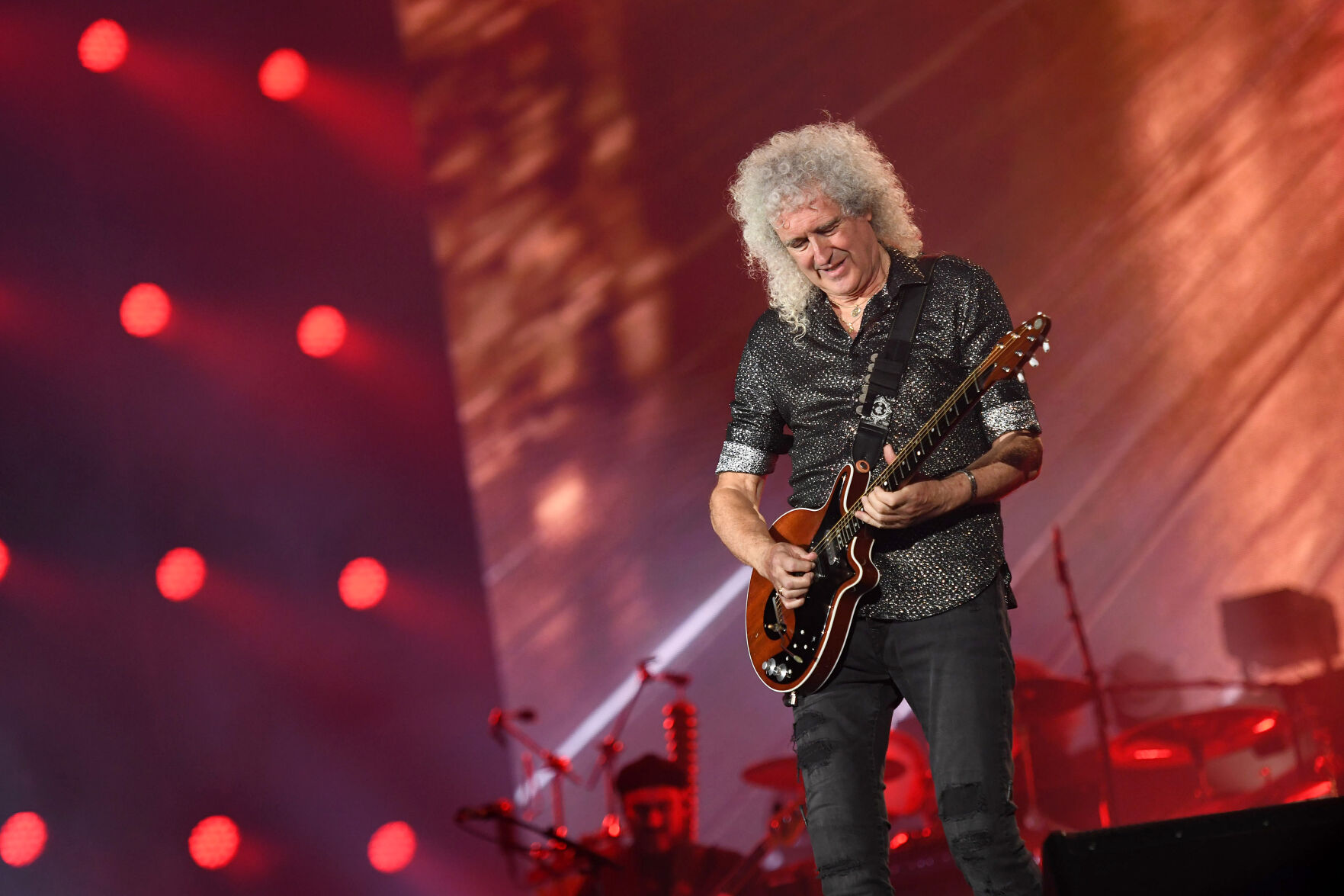 Why Does Brian May Use A Sixpence Coin As A Pick? He Explains In A