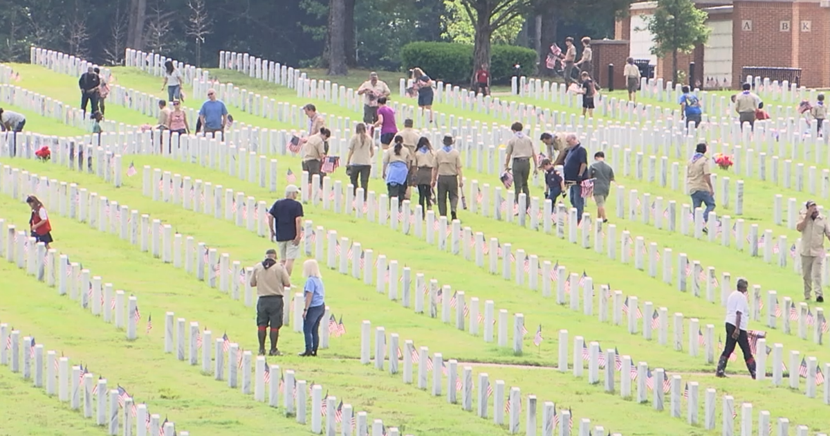 Volunteers place flags at West Tennessee Veterans Cemetery ahead of Memorial Day