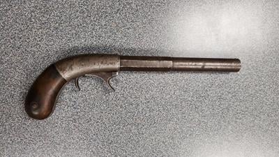 Man arrested, accused of robbing liquor store with antique gun