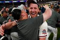 Atlanta Braves shortstop Dansby Swanson kisses Atlanta Braves' Ozzie Albies  on his head before Game 6 of baseball's National League Championship Series  against the Los Angeles Dodgers Saturday, Oct. 23, 2021, in