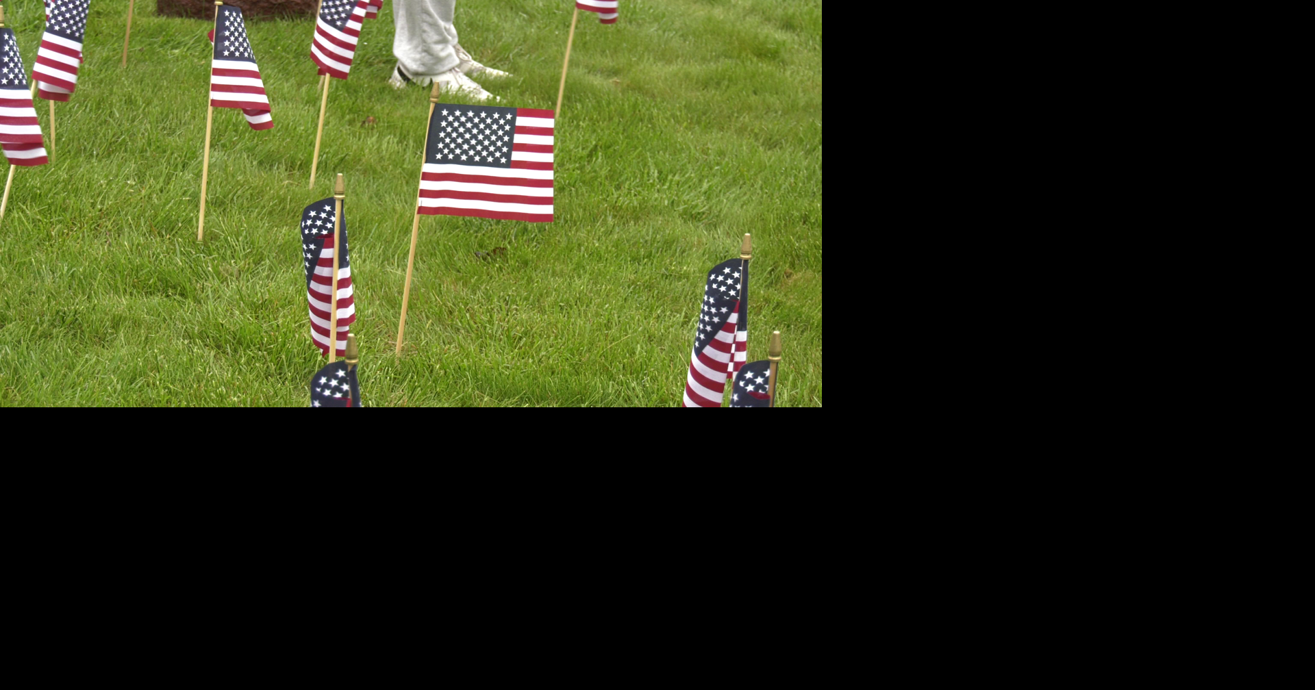 Volunteers gather at Cole Land Transportation Museum to place flags ...