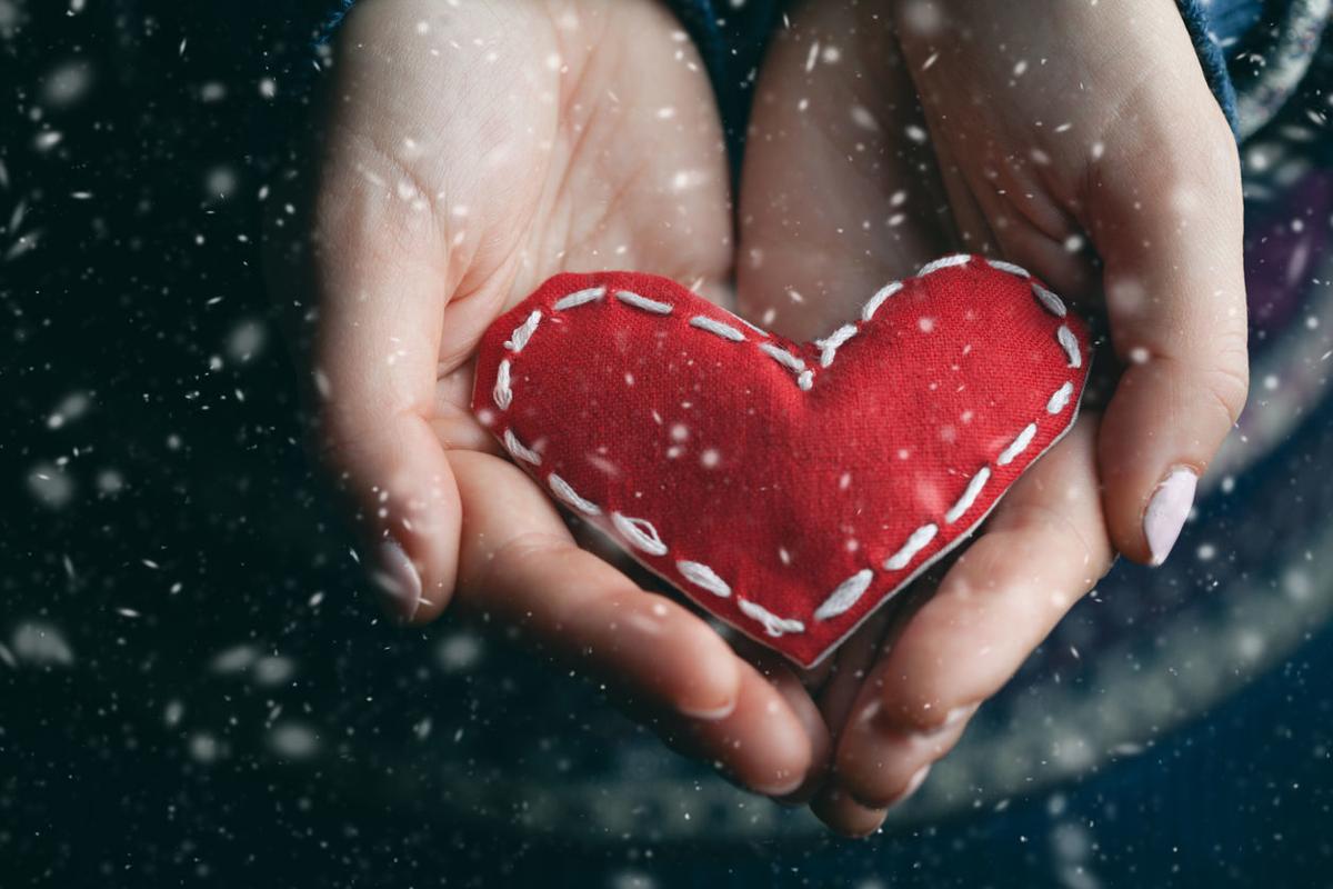 Female hands giving red heart. Close up.