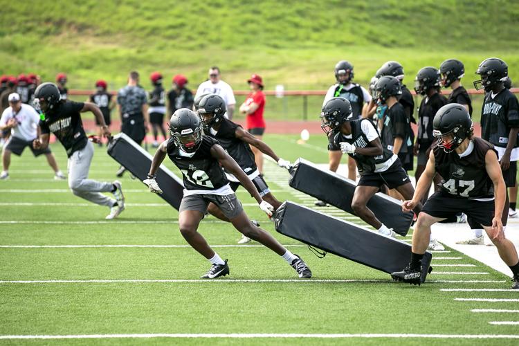 High school football teams open practice in the heat