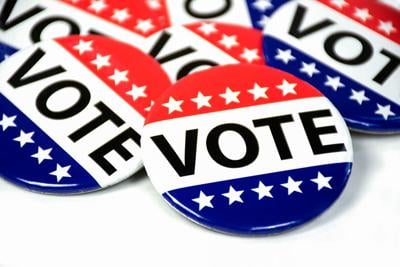 close up of campaign voting flag pins on white