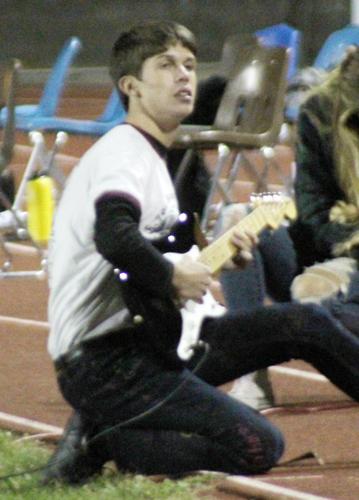 Playing electric guitar for crowd