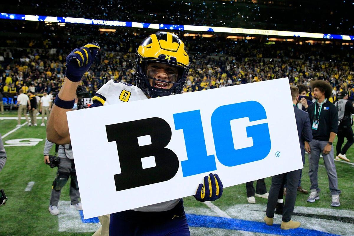 TJ Guy #42 of the Michigan Wolverines celebrates winning the Big Ten Football Championship game against the Iowa Hawkeyes at Lucas Oil Stadium on Dec. 4, 2021, in Indianapolis, Indiana.