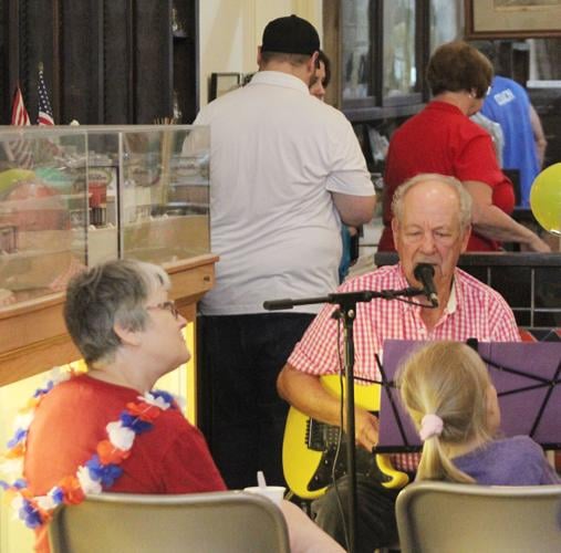 Larry Hanson plays guitar in museum