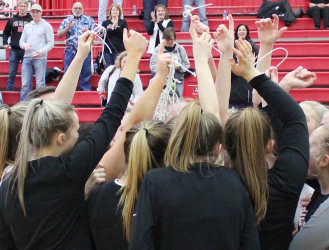 Team celebrates with pieces of net