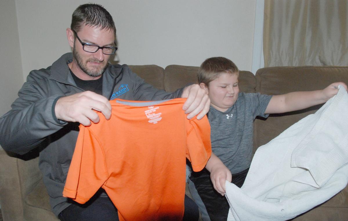 Single dad and son folding clothes