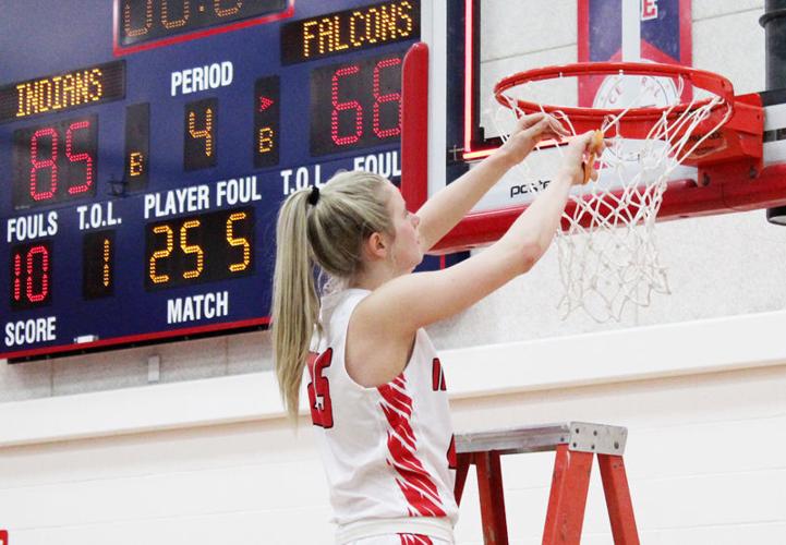 Peyton Barrett cutting down nets with scoreboard