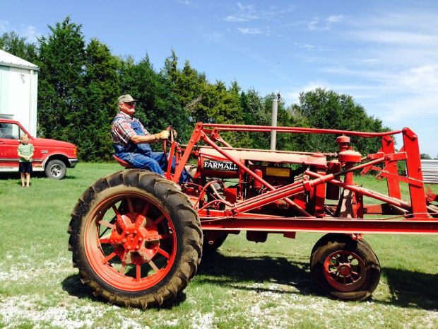 Hammons family enjoys day riding antique Farmalls