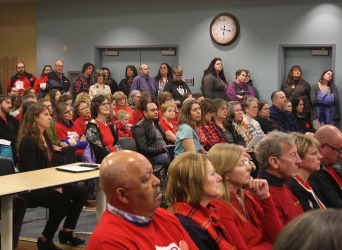 Local teachers wear red, voice concerns about potential cuts to