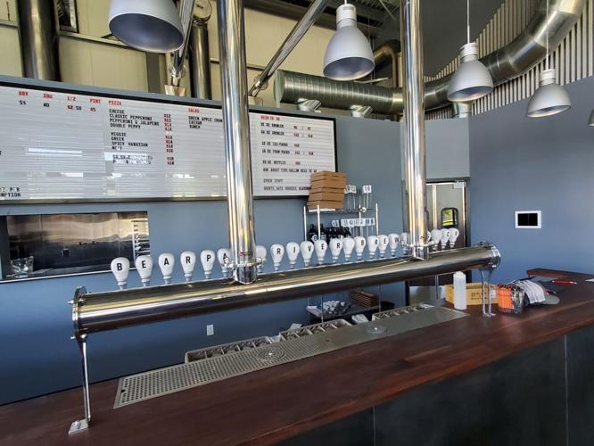 Bearpaw River Brewing Company celebrating new location with ribbon
