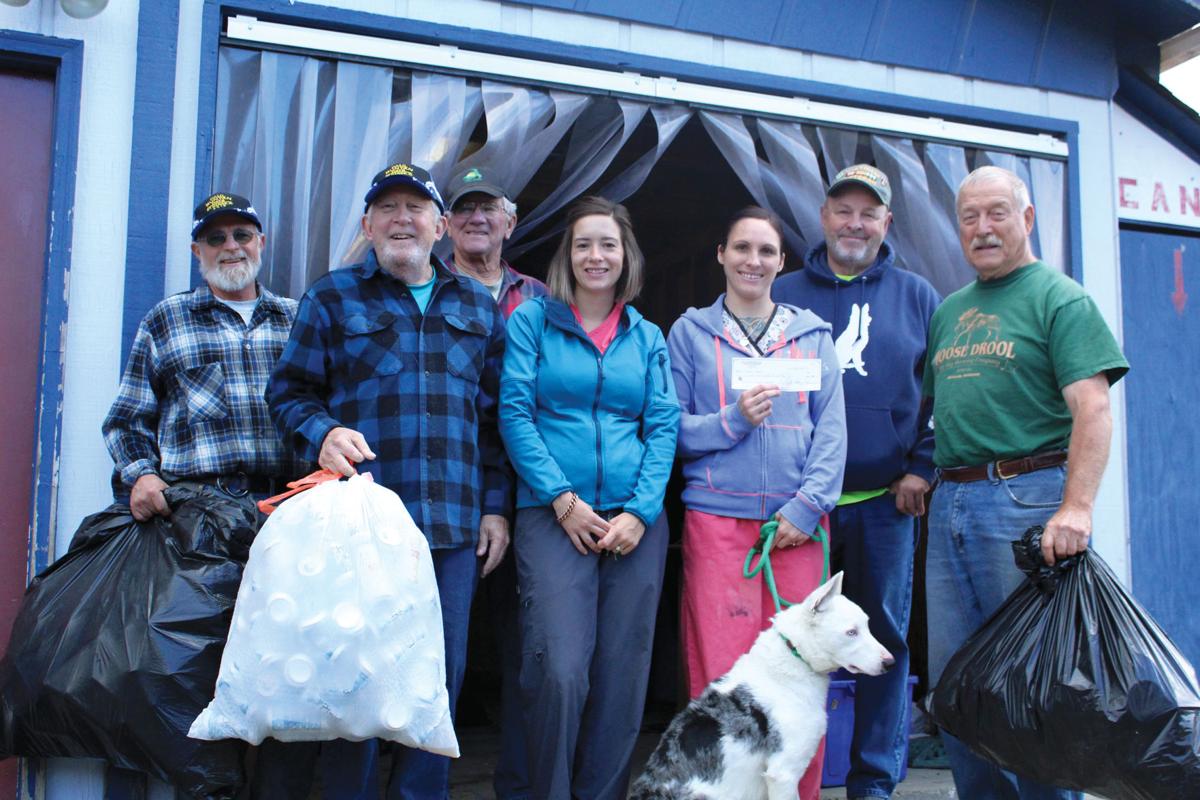 Volunteers recycle cans for animal shelter