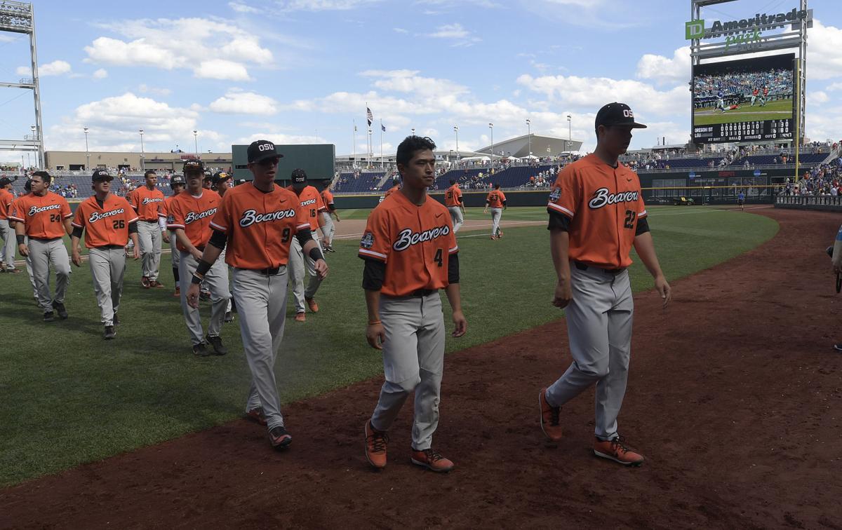 Oregon State's Steven Kwan, left and Adley Rutschman sit on top of