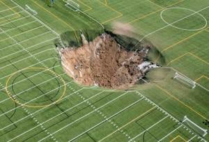 Watch giant sinkhole open up under soccer park after mine collapse