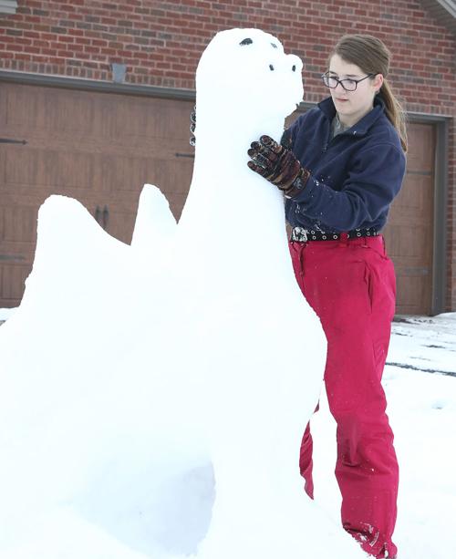 Snow artist builds dragon