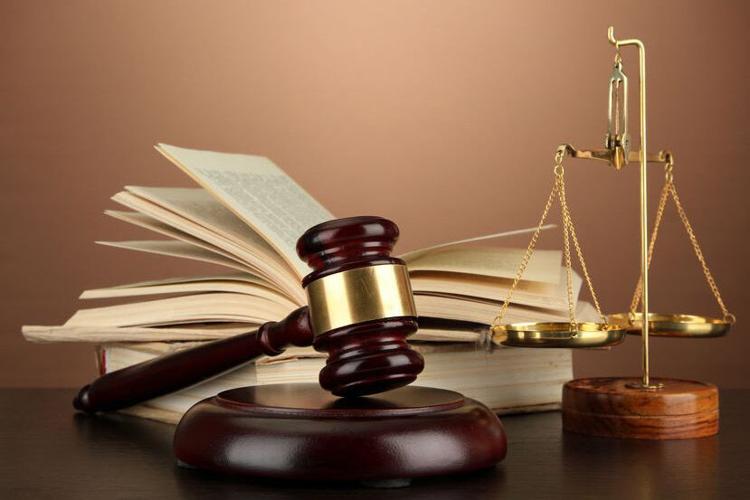 17291733 - golden scales of justice, gavel and books on brown background