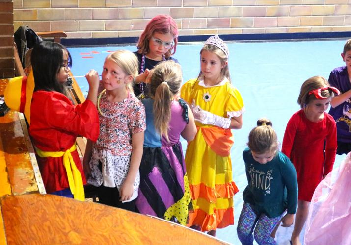 At left, Erica Doroteo, 12, the daughter of James and Grace Doroteo of JED's Lights and Sounds paints faces at the Forest City Parks and Rec Elementary Halloween Party..JPG