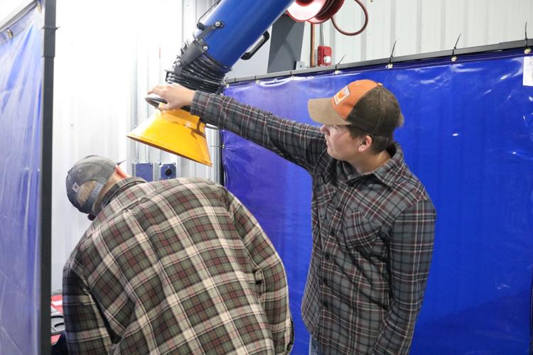 Seniors Blake Groves and Sam Turner check out a new welding station hood at the John V. Hanson Career Center..JPG