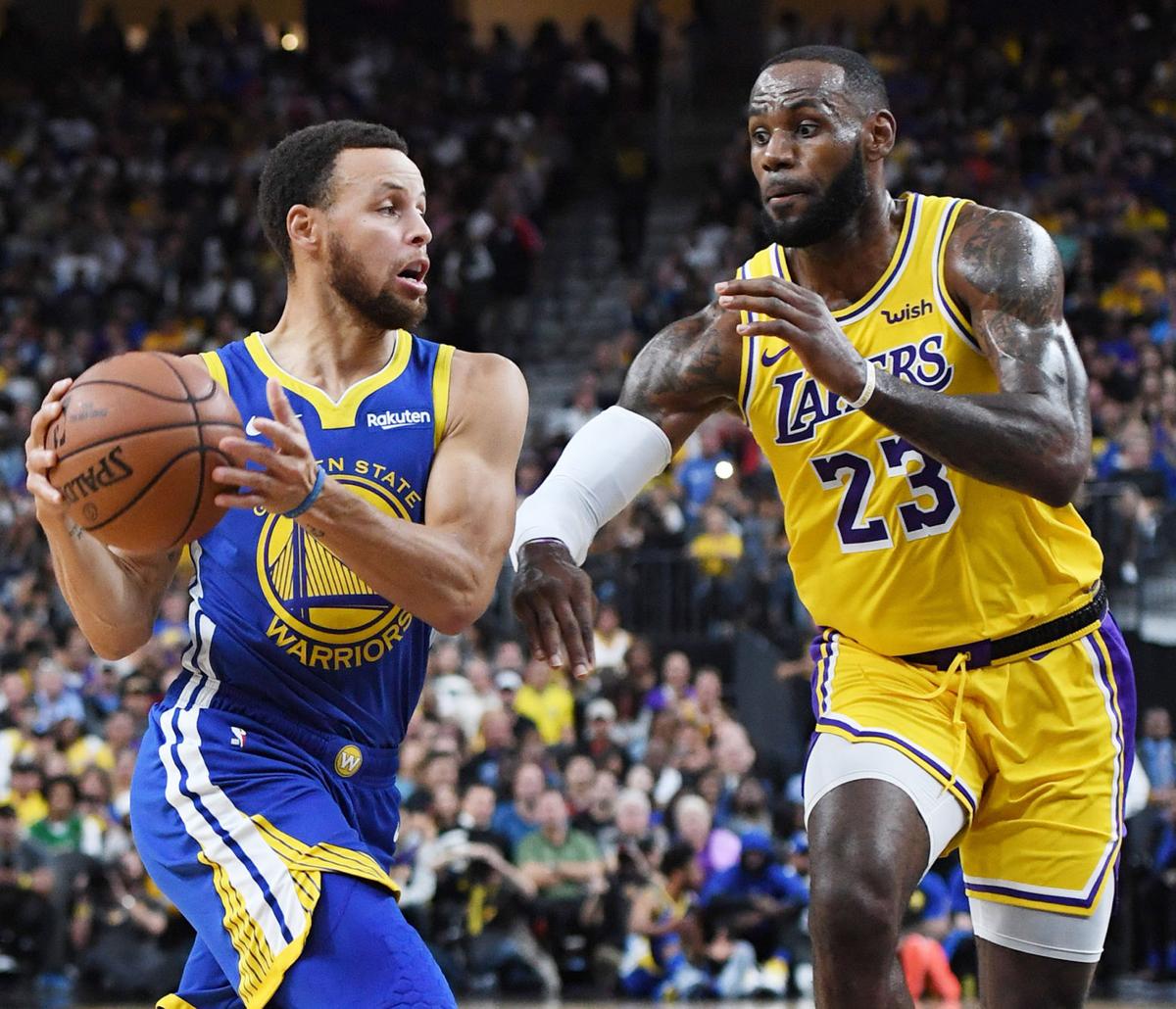 Stephen Curry #30 of the Golden State Warriors drives against LeBron James #23 of the Los Angeles Lakers during their preseason game at T-Mobile Arena on October 10, 2018 in Las Vegas, Nev.