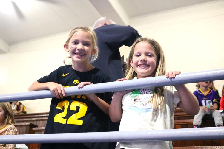 Elyse Zrostlik (8) and Jordy Johnson (7) are all smiles. Behind them Steve Hall serves ice cream cone treats to kids at the Parks and Rec Elementary Halloween Party..JPG