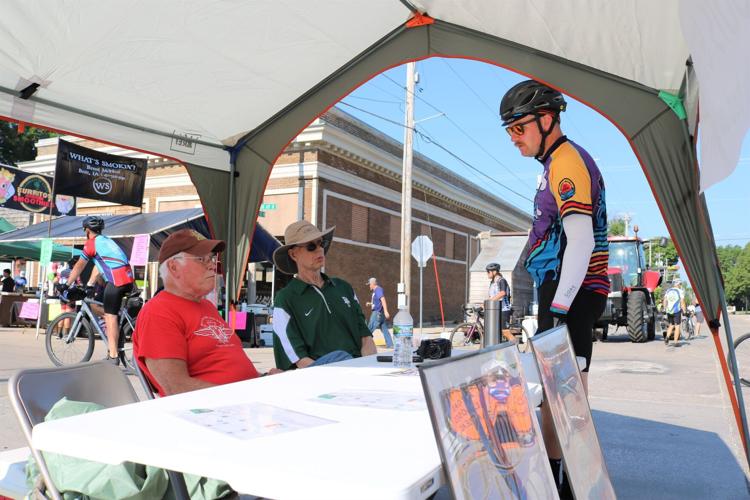 Earl Hill and Paul Delger chat with RAGBRAI participant Kristian Larsen .JPG