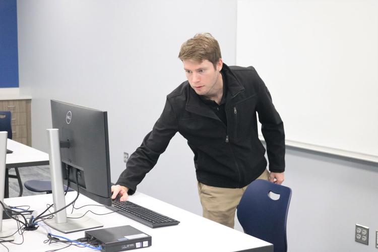 Cody Weiner of Solutions Management Group, which provides tech services for NIACC, makes sure all computers are up and running seamlessly at the John V. Hanson Career Center open house..JPG