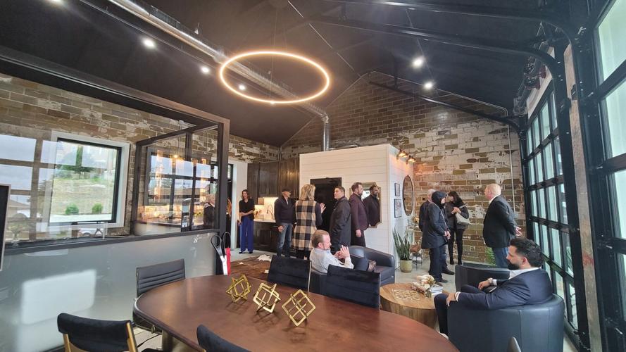 Shown at center in new TerraWealth building space in Forest City is State Rep. Henry Stone of Forest City. Seated at right is one of TerraWealth's founders, Joshua Mauk..jpg