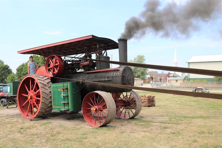 John Fuls of Kanawha is shown manning a coal-fired steam engine at the Heritage Park Steam Threshing Festival..JPG