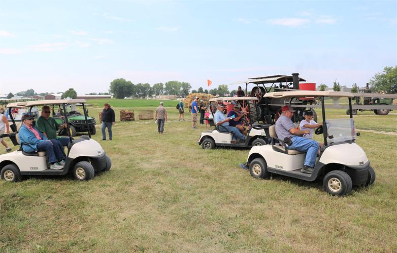 Many spectators boarded golf carts to travel to various activities on the Heritage Park grounds during the steam threshing festival..JPG